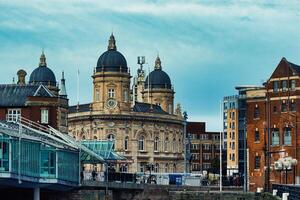 Historic European architecture with domed buildings and modern elements under a cloudy sky. photo