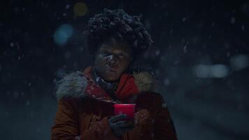 zwart vrouw persoon met gekruld haar- Holding kaarslicht in besneeuwd winter weer video