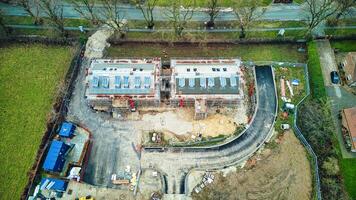 Aerial view of a residential construction site with unfinished houses and building materials. photo