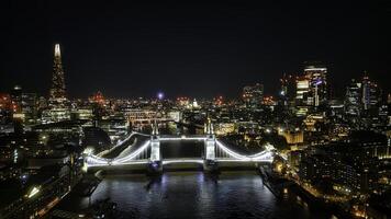 Scenic aerial view of the Tower Bridge and city at night in London photo