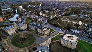 Aerial view of a historic city at dusk with a round tower, buildings, and a river in York, North Yorkshire photo