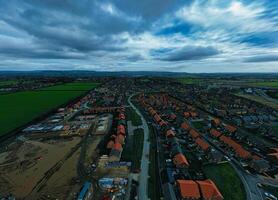 Aerial view of a suburban neighborhood with rows of houses under a dramatic cloudy sky. photo