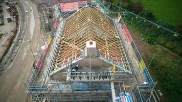 Aerial view of a building under construction with exposed wooden beams and scaffolding. photo