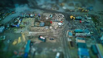 Tilt-shift aerial view of a construction site with machinery and vehicles. photo