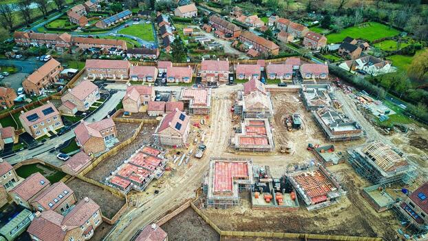 Aerial view of a residential construction site with partially built houses and infrastructure. photo