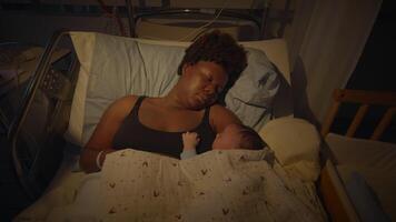 Young African Mother Lying in Hospital Bed Holding Newborn Baby After Birth video