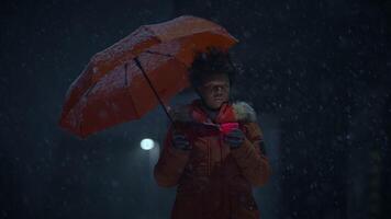 Black Female Person with Curly Hair Holding Candlelight in Snowy Winter Weather video