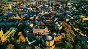 Aerial view of a historic city Lancaster at sunset with warm lighting highlighting architectural details and dense urban landscape. photo