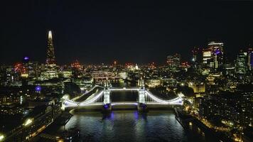 Scenic aerial view of the Tower Bridge and city at night in London photo