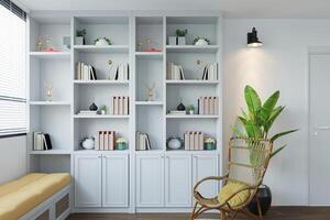 a bookcase with carefully arranged books, accompanied by a potted plant, within a white interior. photo