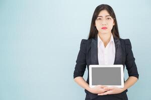 Young women in suit holding her digital tablet photo