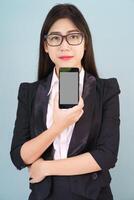 Young women in suit holding her smartphone photo