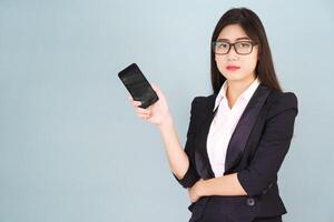 Young women in suit holding her smartphone photo