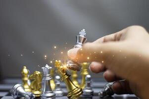 Concept. Businessman moving chess pieces in a successful competition. Management strategy or leadership concept photo