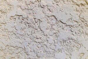 Rough and chunk surface white cement wall with vignette. photo