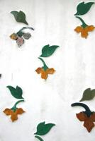 Flowers and leaf on white wall of history site in temple, native ancient art in Bangkok,Thailand. photo