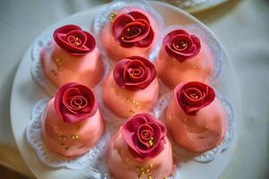 Milk jelly as roses on a white plate photo