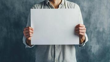 AI generated Man confidently holds sheet of paper against a neutral grey background, exuding professionalism. Ai Generated. photo