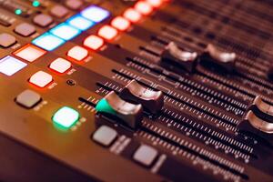mixing console for recording with faders and bright buttons is in the building. Close-up photo