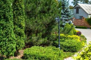 Beautiful landscape design with colorful plants. Home exterior photo