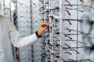 Row of glasses at an opticians. Eyeglasses shop. Stand with glasses in the store of optics. photo