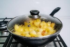 Fried potatoes in a frying pan photo