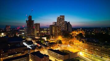 Dusk cityscape with illuminated buildings and a deep blue sky in Leeds, Yorkshire. photo