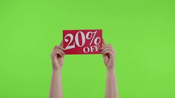 20 Percent Off advertisement inscription on paper sheet in womans hands on chroma key. Slow motion video