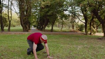 Active senior sportsman 80 years old doing push-ups exercise. Workout cardio in park for grandfather video