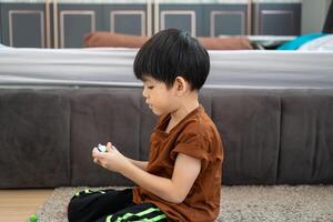 Asian boy playing with plasticine in the room photo