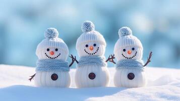 AI generated Charming knitted snowmen nestled on soft snow against a serene blue backdrop, evoking winter wonder. Ai Generated. photo