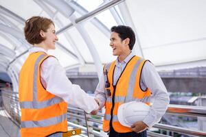 Team of diversity engineer is having and handshake after done inspecting the construction project for modern architecture and real estate development hand over photo