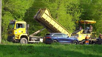 Ternopil, Ukraine, May 2020. Road workers lay asphalt. Road works video