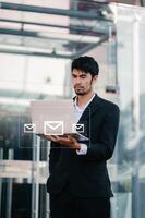 Woman hands using Laptop, tablet typing on keyboard and surfing the internet with email icon, email marketing concept, send e-mail or newsletter, online working photo