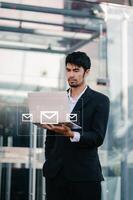 Woman hands using Laptop, tablet typing on keyboard and surfing the internet with email icon, email marketing concept, send e-mail or newsletter, online working photo