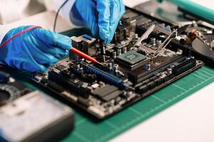 The technician is putting the CPU on the socket of the computer motherboard. electronic engineering electronic repair, electronics measuring and testing, repair photo