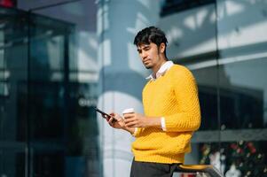 Business Asian man in the office with copy space hand holding laptop, smartphone and tablet portable photo