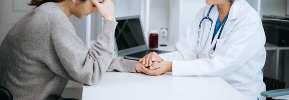 Psychology, depression. Suffering asian woman, consulting with psychologist, psychiatrist while patient counseling mental problem. Encouraging, therapy, health care. photo