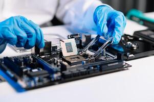 The technician repairing the motherboard in the lab with copy space. the concept of computer hardware, mobile phone, electronic, repairing, upgrade photo