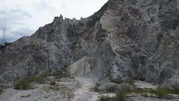 Rocky cliff with trees on a cloudy day. Natural background. video