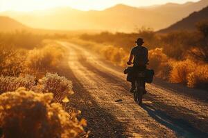 ai generado silueta de un bicicleta viajero montando un bicicleta en campo la carretera a un puesta de sol o amanecer foto