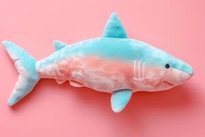 AI generated toy soft plush shark in pastel colors on a pink background photo