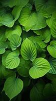 ai generado botánico abundancia repetido modelo de vibrante verde hojas antecedentes vertical móvil fondo de pantalla foto