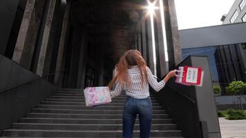 Girl with shopping bags, spining, dancing, looking satisfied with purchase, enjoying price discounts video