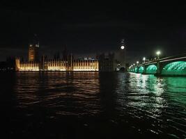 Houses of Parliament and Westminster Bridge at night in London photo