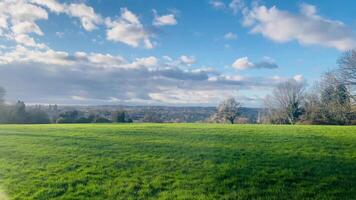 Idyllic English countryside view with vibrant green fields under a blue sky in early spring in Hemel Hempstead, Hertfordshire, England, United Kingdom video