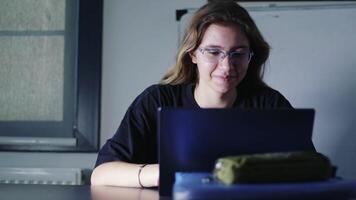 Young girl studies on computer and surfs the internet video