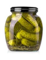 Pickled cucumbers in glass jar on a white background with clipping path photo