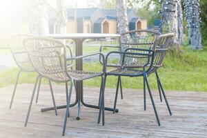 Black metal table and chairs in garden. Close up photo