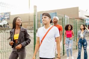 Latin american young friends walking in neighborhood. photo